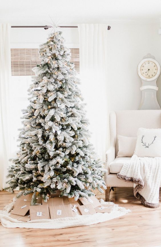 a lovely wonderland Christmas tree with lights, silver and blush ornaments, a white fluffy farland is amazing