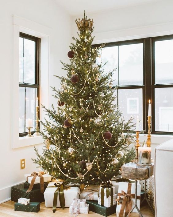 a modern flocked Christmas tree with white and gold ornaments is a chic idea that brings ultimate elegance