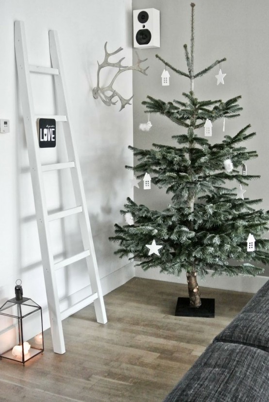 a small Christmas tree in a paper bag, with just a couple of wooden ornaments is a lovely idea for a rustic space